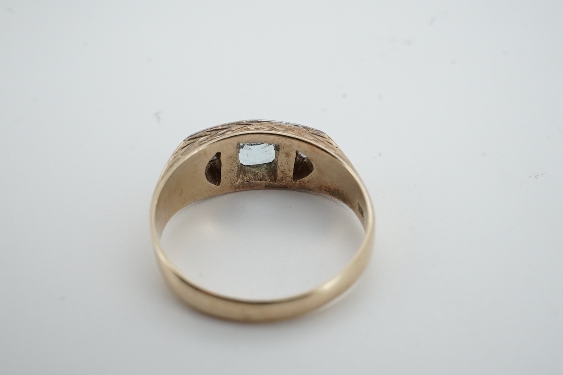 A mid 20th century yellow metal (stamped 585), aquamarine and diamond set three stone ring, size 0, gross weight 4.6 grams.